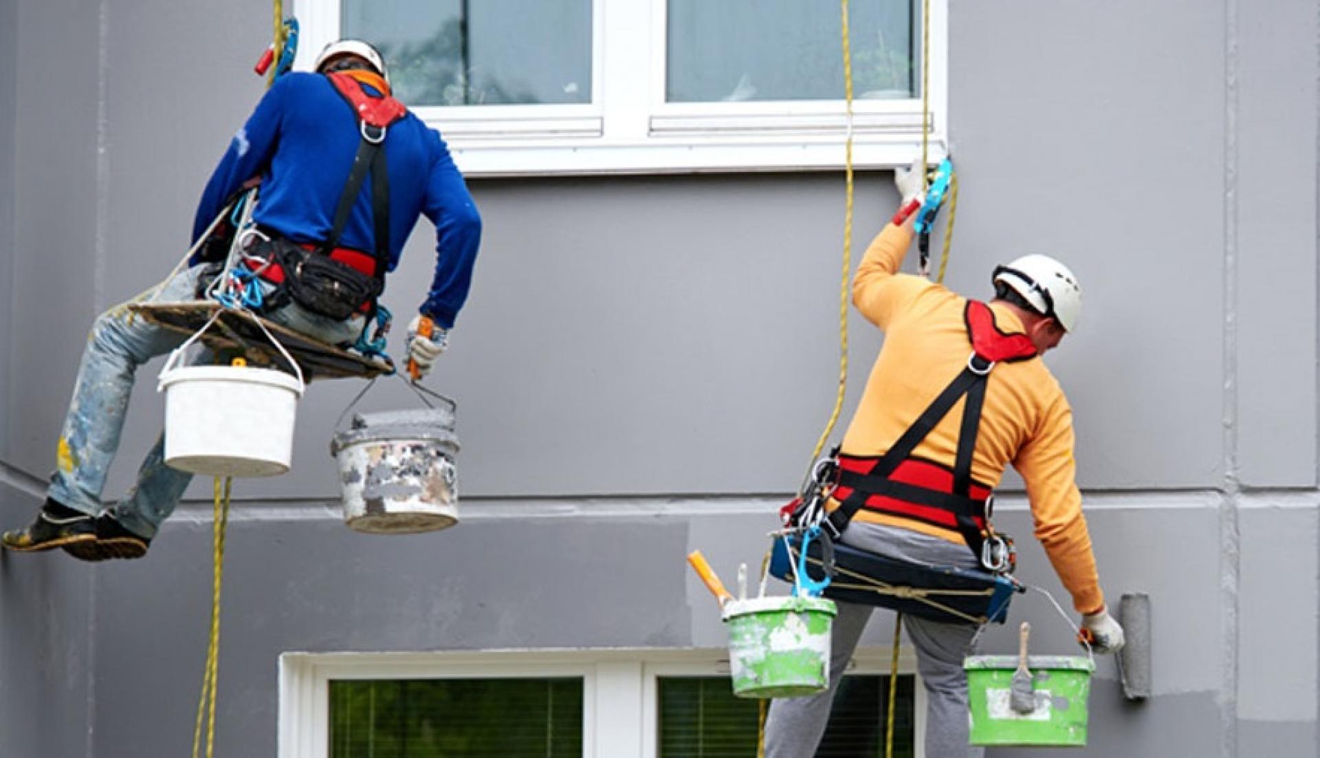 Equipe realizando manutenção de fachada com acesso por cordas